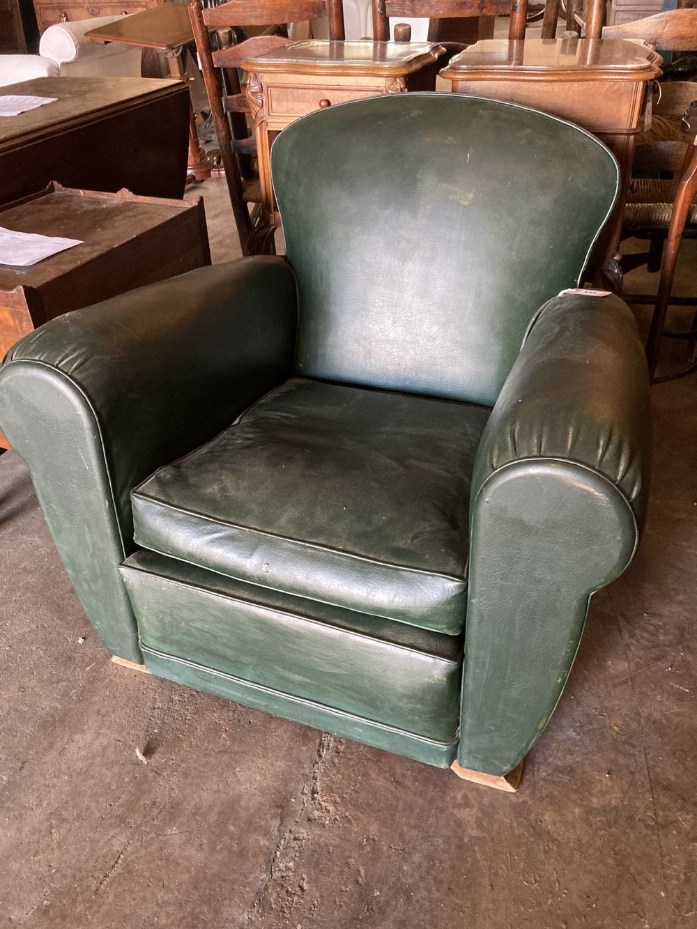 An Art Deco green leatherette armchair